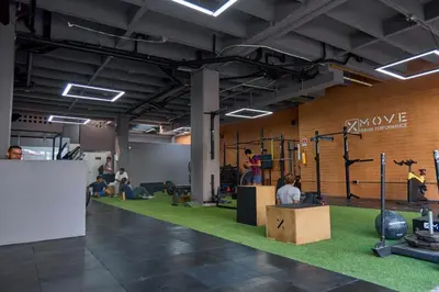 a gym with people sitting on a green carpet at Cozy Comforts at Rosa Negra Stadio in Medellín