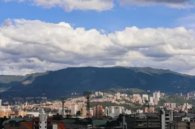 a view of a city with mountains in the background at Stadio Aparta-Suite Bliss Rosa Negra in Medellín