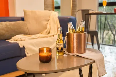 a table with two bottles of champagne on it at Inviting Stadio Suite Rosa Negra in Medellín