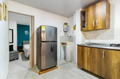 a kitchen with a stainless steel refrigerator in a room at Studio apartment in La Floresta near the subway in Medellín