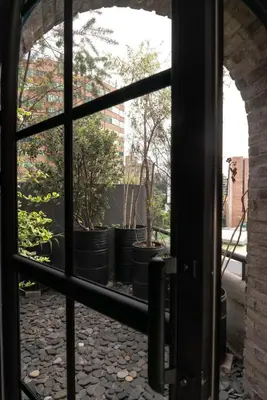 a view through a window of potted plants at Vive Pisoverde - a Loft with a green soul in Medellín