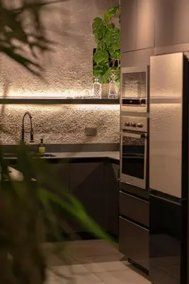 a kitchen with a sink and a stove at Vive Pisoverde - a Loft with a green soul in Medellín