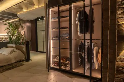 a walk in closet with a bed in a room at Vive Pisoverde - a Loft with a green soul in Medellín