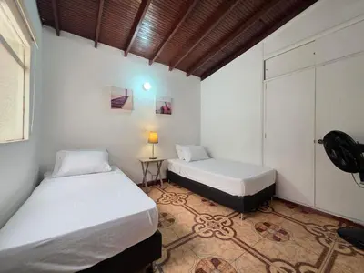 a bedroom with two beds and a lamp in it at 5StarHomes - Casa privada cerca al Estadio y la 70 in Medellín