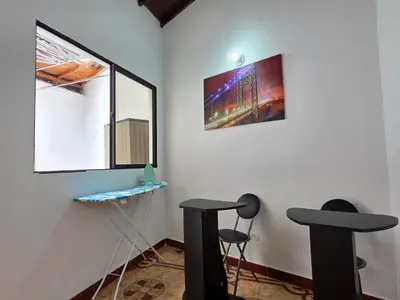 a room with two black stools and a mirror at 5StarHomes - Casa privada cerca al Estadio y la 70 in Medellín