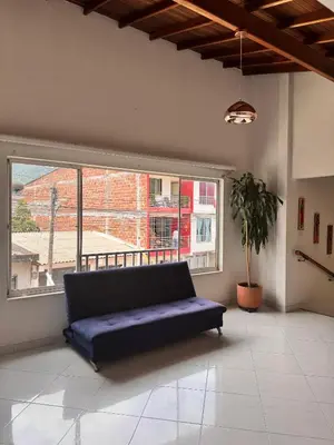 a couch in a room with a large window at Hotel Premium BISS in Supía