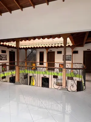 a building with a fence with vines on it at Hotel Premium BISS in Supía