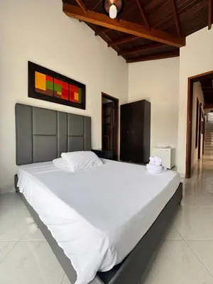 a bedroom with a large white bed in a room at Hotel Premium BISS in Supía