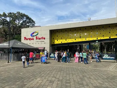 a group of people standing outside of a shopping center at Hotel Familiar in Medellín