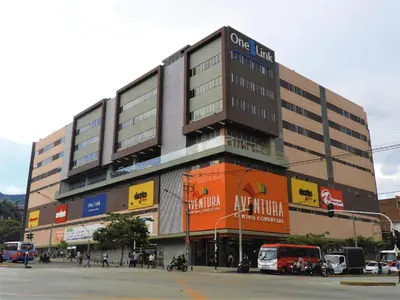 a large building with people standing outside of it at Hotel Familiar in Medellín