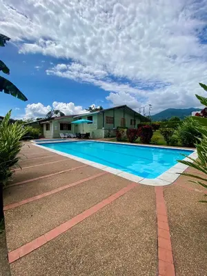 a swimming pool in front of a house at Finca Villa Juan Pablo in Anserma