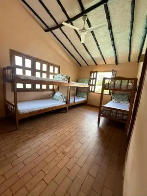 a room with three bunk beds and two windows at Finca Villa Juan Pablo in Anserma