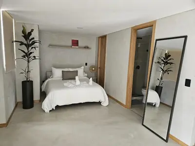 a bedroom with a bed and a large mirror at 2402 Luxury apartment in Sabaneta in Sabaneta