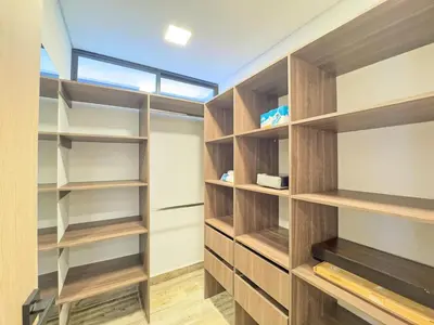 a walk in closet with wooden shelves and a window at 3BR Esmeralda Country Home Santa Elena in Santa Elena