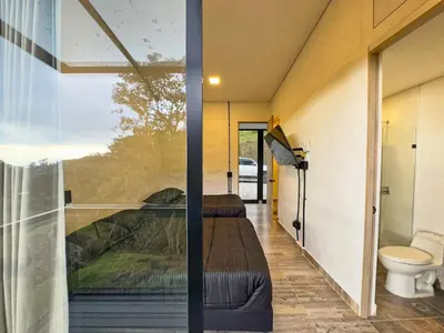 a room with two beds and a window at 3BR Esmeralda Country Home Santa Elena in Santa Elena