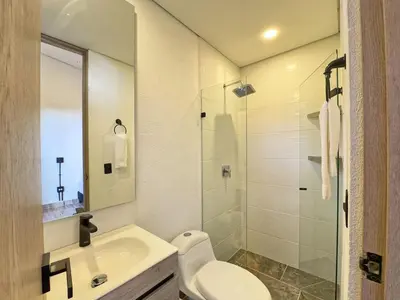 a bathroom with a toilet and a sink and a shower at 3BR Esmeralda Country Home Santa Elena in Santa Elena
