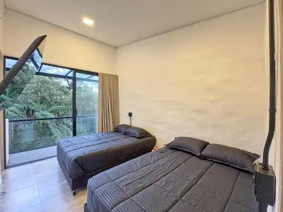 a bedroom with two beds and a large window at 3BR Esmeralda Country Home Santa Elena in Santa Elena