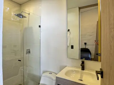 a bathroom with a glass shower and a sink at 3BR Esmeralda Country Home Santa Elena in Santa Elena