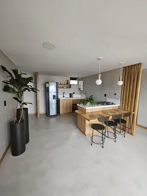 a kitchen with a table and chairs and a refrigerator at 2404 Luxurious apartment with Jacuzzi in Sabaneta