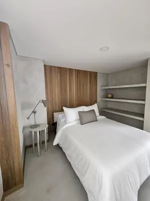 a bedroom with a large white bed and a table at 2404 Luxurious apartment with Jacuzzi in Sabaneta
