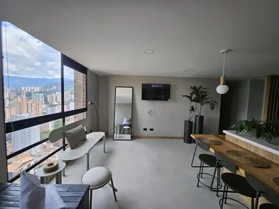 a living room with a view of a city at 2404 Luxurious apartment with Jacuzzi in Sabaneta