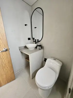 a bathroom with a toilet and a sink and a mirror at 2404 Luxurious apartment with Jacuzzi in Sabaneta