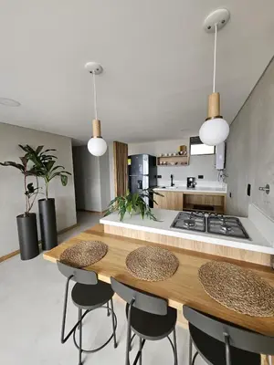 a kitchen with a table and some chairs and a counter at 2404 Luxurious apartment with Jacuzzi in Sabaneta