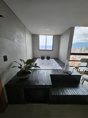 a bathroom with a tub with a potted plant in it at 2404 Luxurious apartment with Jacuzzi in Sabaneta