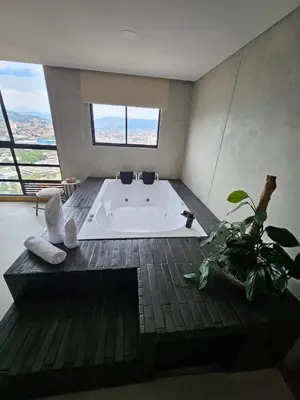 a large bath tub in a bathroom with a window at 2406 Luxurious apartment with jacuzzi in Sabaneta