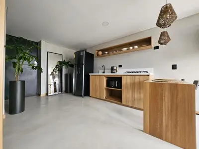 a kitchen with a black refrigerator and wooden cabinets at 2406 Luxurious apartment with jacuzzi in Sabaneta