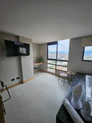 a large living room with a tv and a couch at 2406 Luxurious apartment with jacuzzi in Sabaneta