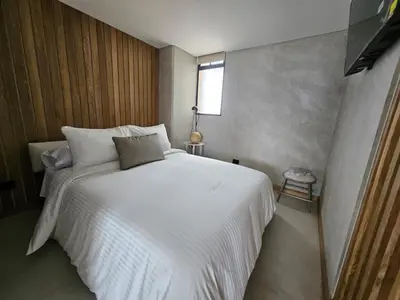a bedroom with a white bed and a window at 2406 Luxurious apartment with jacuzzi in Sabaneta