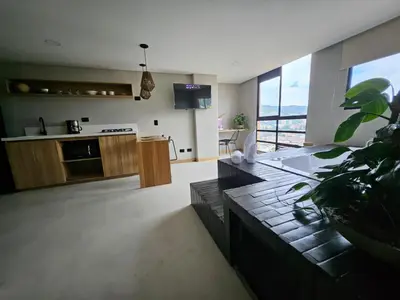 a living room with a kitchen and a living room with a couch at 2406 Luxurious apartment with jacuzzi in Sabaneta