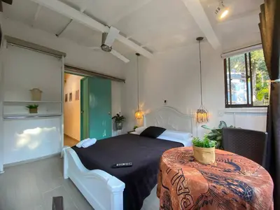 a bedroom with a bed and a table in a room at Aptos en la naturaleza in Medellín