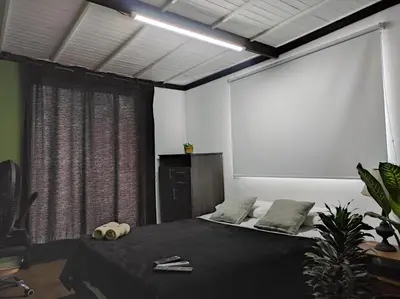 a room with a bed with a large window at Aptos en la naturaleza in Medellín