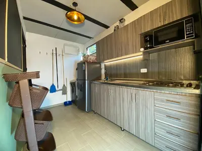 a kitchen with a stove and a refrigerator at Aptos en la naturaleza in Medellín