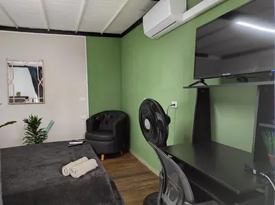 a room with a desk and a tv and a chair at Aptos en la naturaleza in Medellín