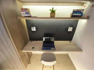 a tiny office with a desk with a laptop on it at Aptos en la naturaleza in Medellín