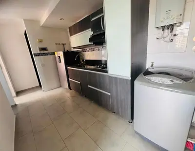 a small kitchen with a washing machine in a room at Apartaestudio de 2 habitaciones cerca a provenza y el tesoro in Medellín