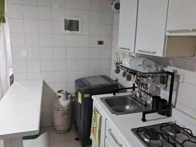 a small kitchen with a sink and a stove at Confortable Apartamento Parque Caldas Manizales in Manizales