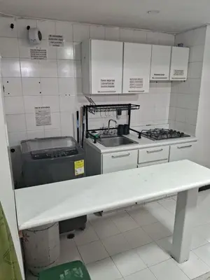 a kitchen with a sink and a stove at Confortable Apartamento Parque Caldas Manizales in Manizales