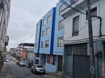 a blue and white building on a city street at Confortable Apartamento Parque Caldas Manizales in Manizales