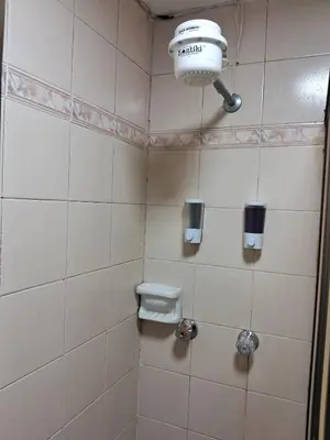 a bathroom with a toilet and a light on the wall at Confortable Apartamento Parque Caldas Manizales in Manizales
