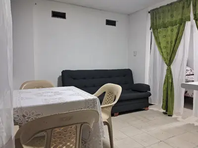 a living room with a table and a couch at Confortable Apartamento Parque Caldas Manizales in Manizales