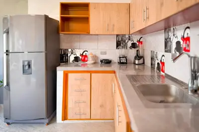 a kitchen with a stainless steel refrigerator and a sink at Casa Bella in Honda