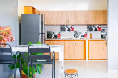 a kitchen with a table with chairs and a refrigerator at Casa Bella in Honda