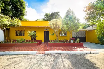 a yellow house with a brick driveway in front of it at Casa Bella in Honda