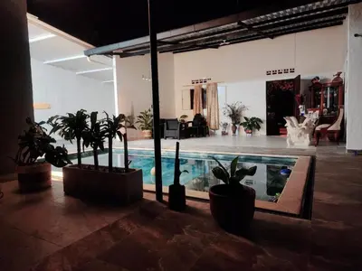 a room with a swimming pool with potted plants at Casa Bella in Honda