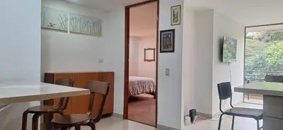 a room with a table and chairs and a bedroom at Espacio en Medellin, Ideal para tu estilo de vida moderno, estrátegico y cómodo in Medellín
