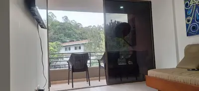 a room with a view of a balcony with a table and chairs at Espacio en Medellin, Ideal para tu estilo de vida moderno, estrátegico y cómodo in Medellín